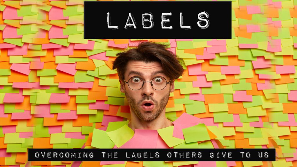 Man surprised by colorful sticky notes labeled 'LABELS' behind him.
