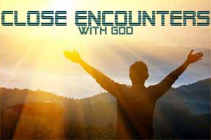 Silhouette with arms raised at sunrise