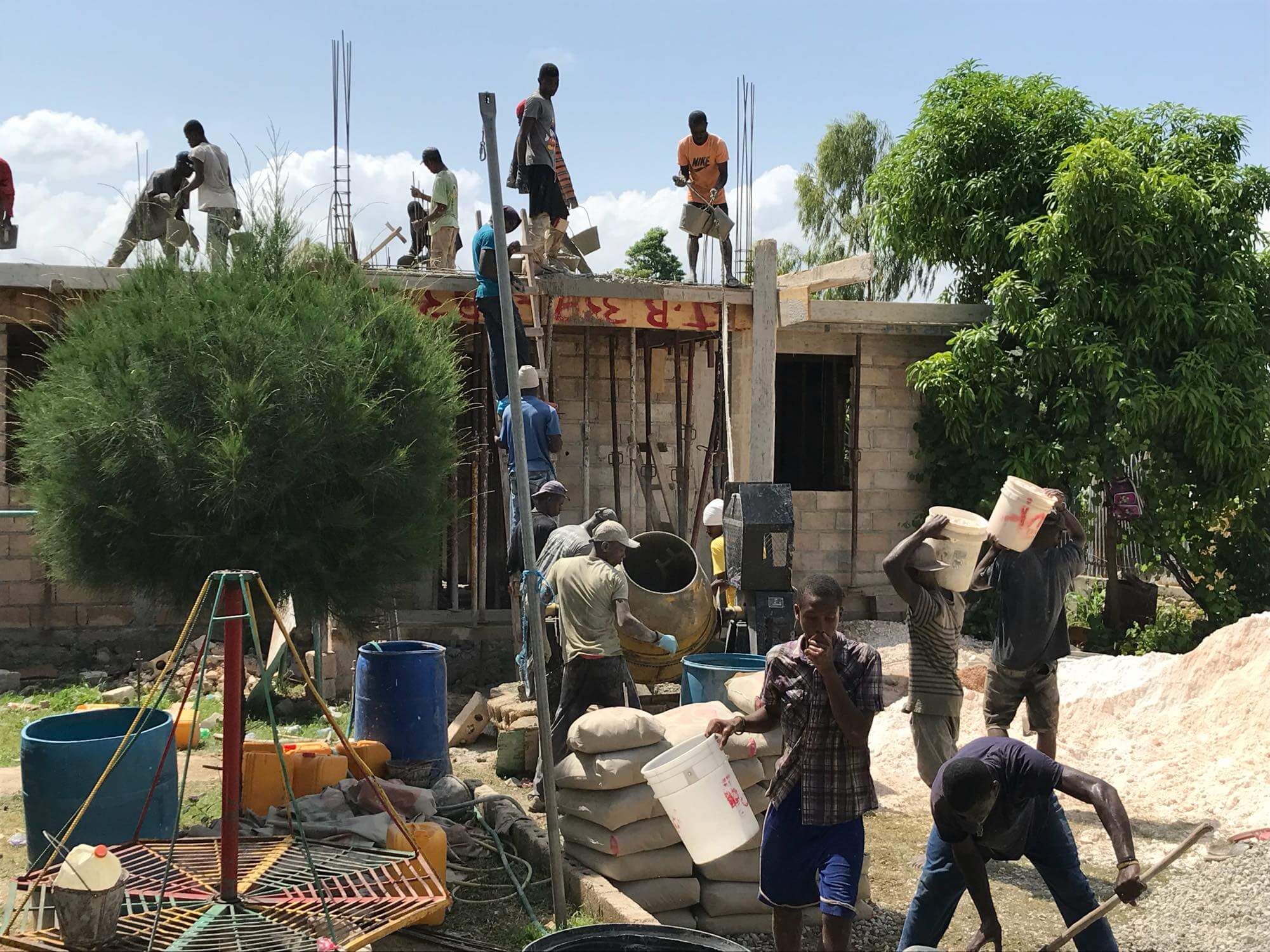 Workers carrying materials at construction site