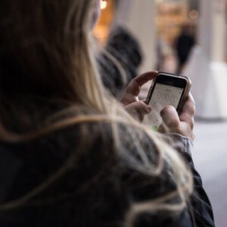 Woman using phone on the street