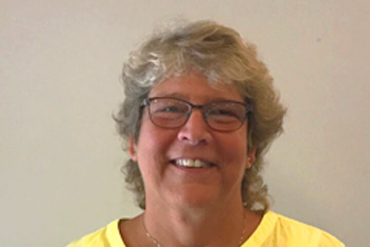 Woman with short hair and glasses