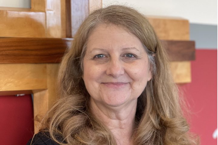 Smiling woman with long hair indoors