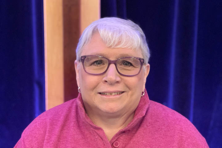 Smiling woman with short white hair