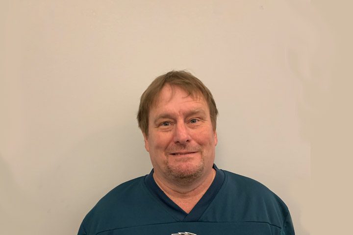 Smiling man in a blue shirt