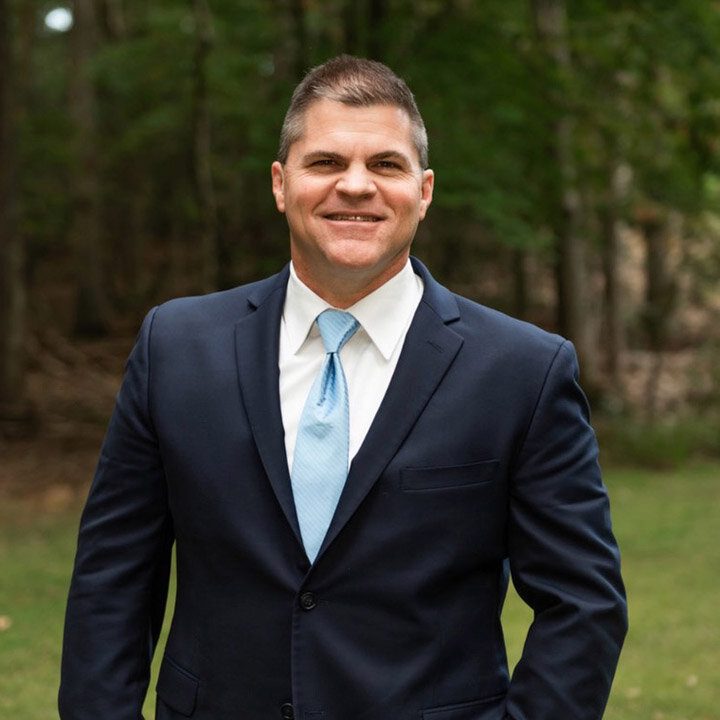 Businessman standing in forest setting