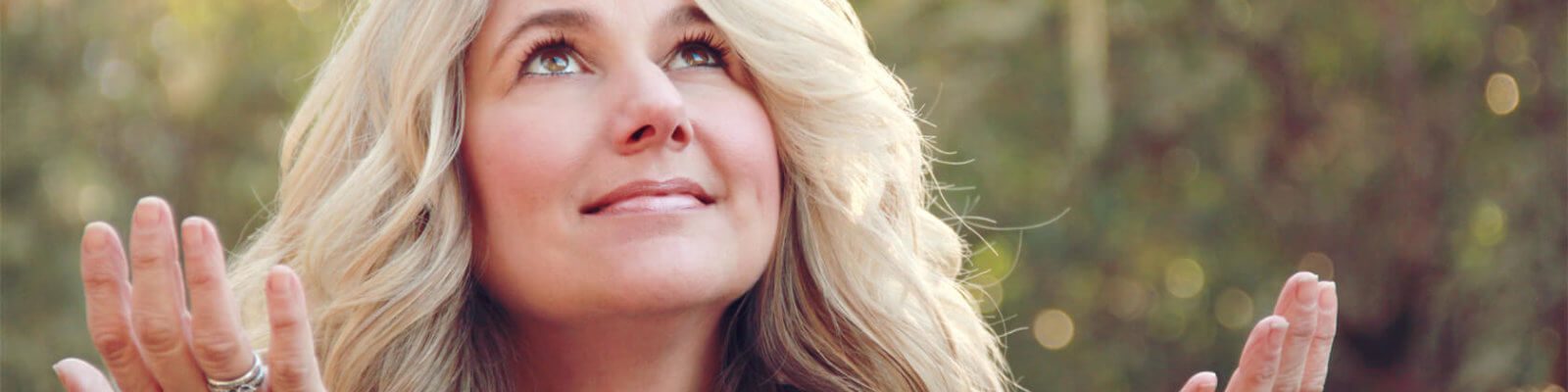 Smiling woman outdoors, serene atmosphere