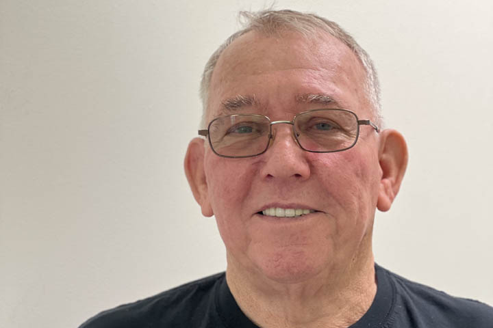 Elderly man smiling with glasses