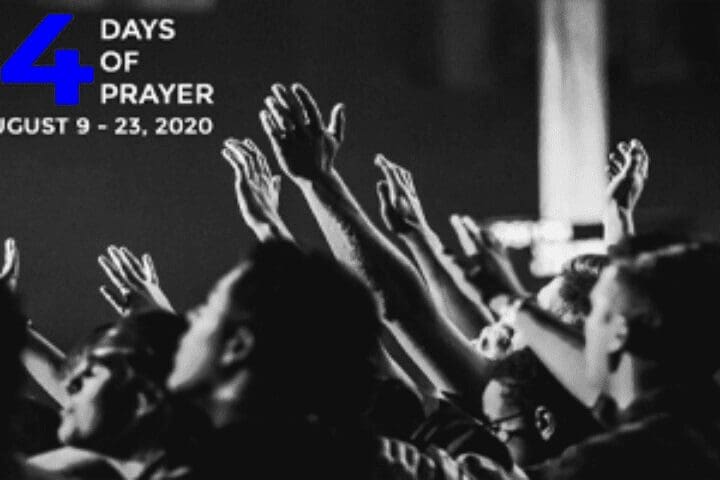 People raising hands in prayer