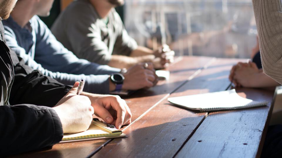 Group discussion at a wooden table